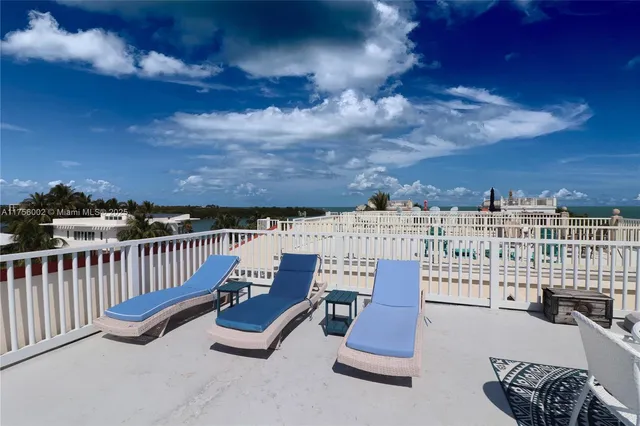 a terrace with outdoor seating and city view