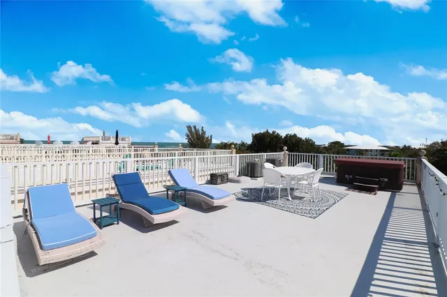 a roof deck with couch and city view