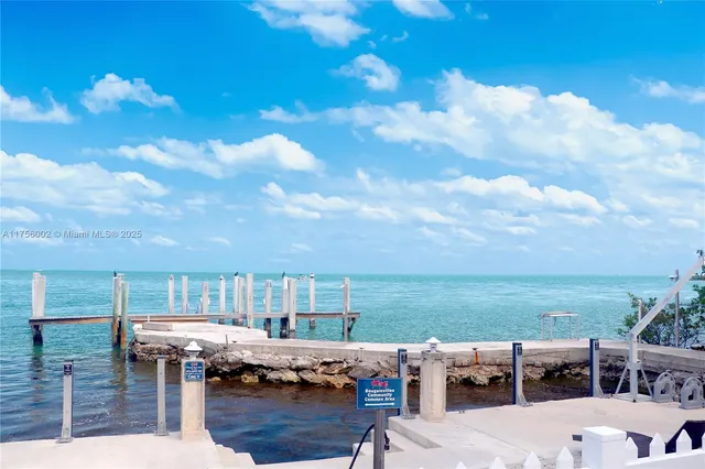 a roof deck with table and chairs