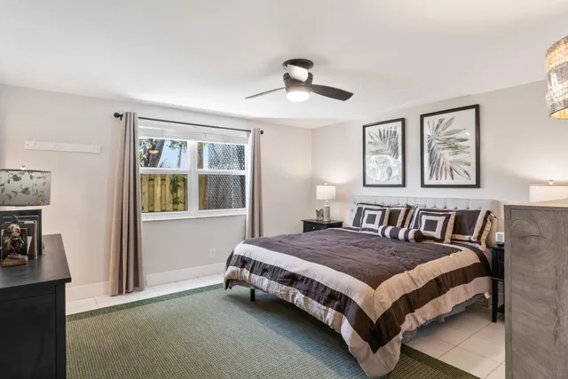 a bedroom with a bed lamp and a window