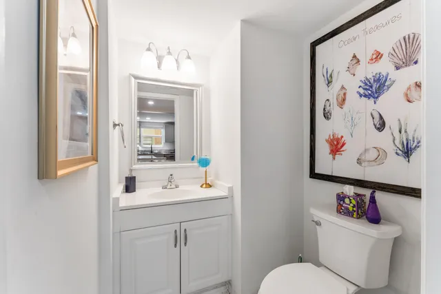 a bathroom with a sink mirror and toilet