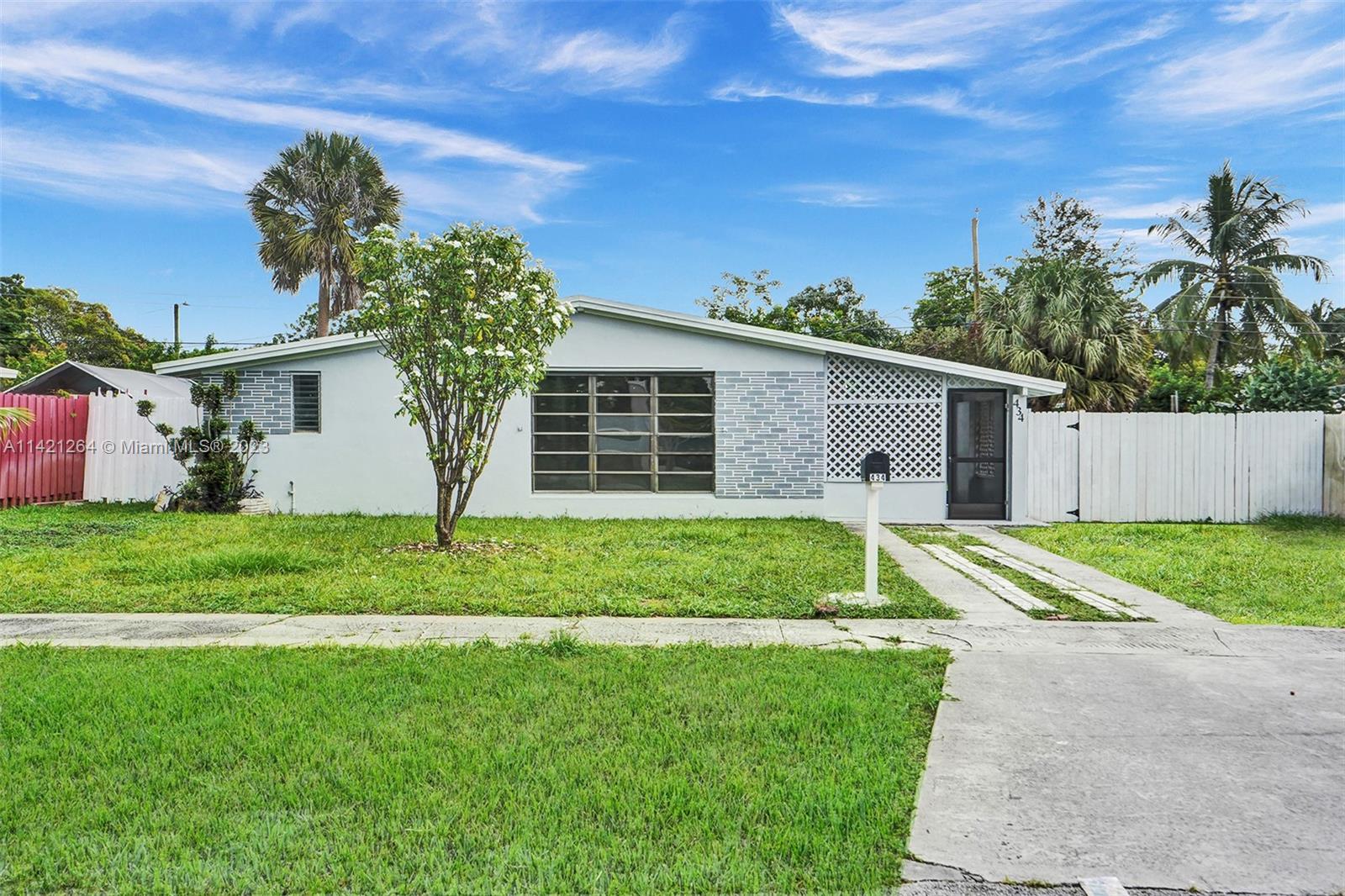 434 Southwest 22nd Terrace Fort Lauderdale, FL 33312 - Photo 1 of 15 a view of a house with backyard and a tree