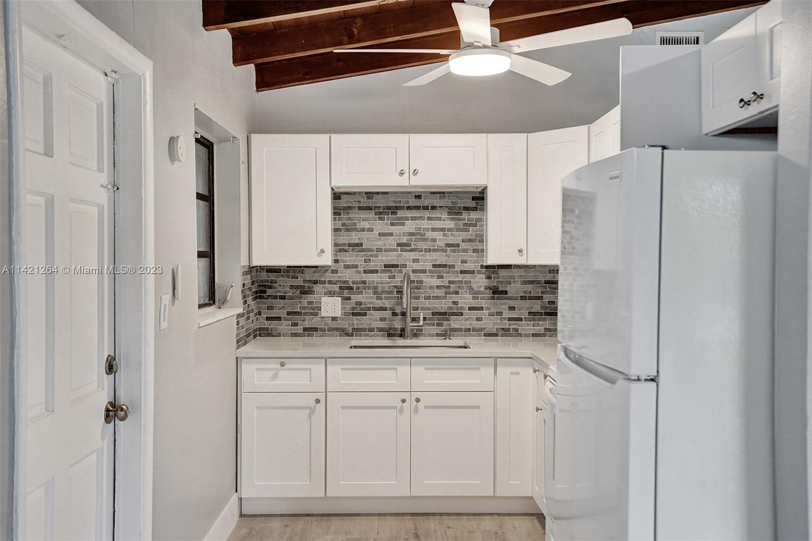 434 Southwest 22nd Terrace Fort Lauderdale, FL 33312 - Photo 5 of 15 a kitchen with stainless steel appliances a refrigerator and cabinets
