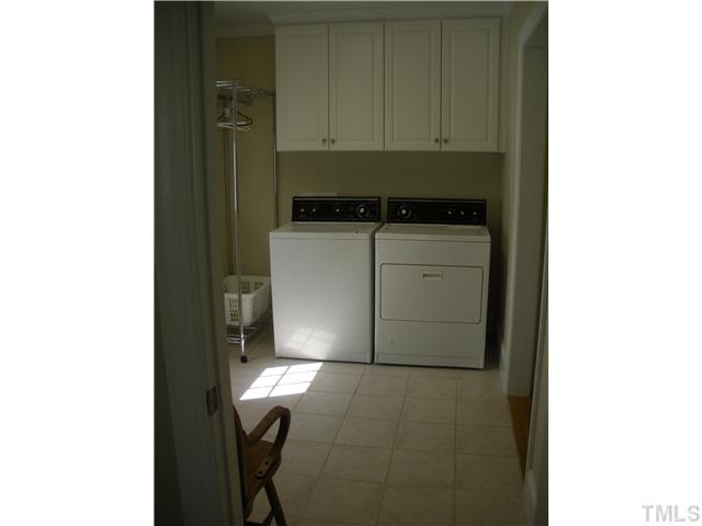1124 Colonial Club Road Wake Forest, NC 27587 - Photo 15 of 25 First Floor bright and sunny laundry room...door exit to the side yard. This view is from the craft room/office...to the right leads to the garage and kitchen entrance.