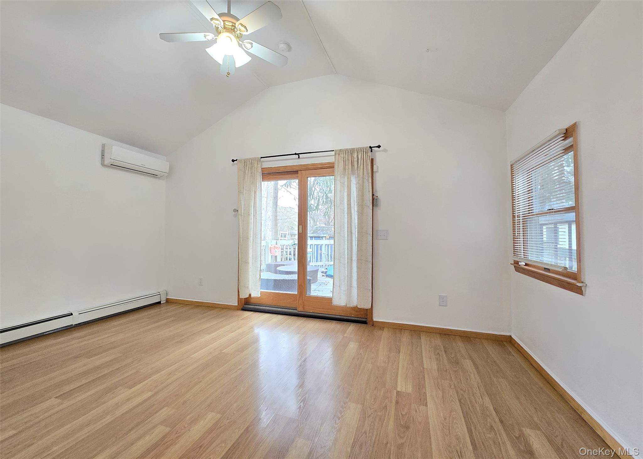 27 Forest Trail Ridge, NY 11961 - Photo 15 of 29 Primary Bedrm Ensuite W/Cathedral Ceiling & Slider Leading To Deck
