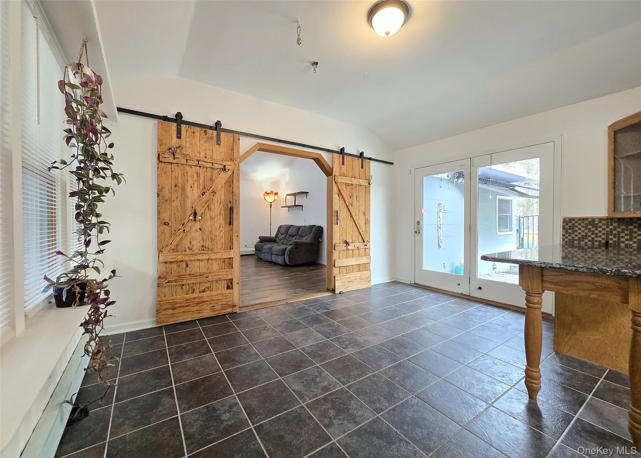 27 Forest Trail Ridge, NY 11961 - Photo 5 of 29 Barn Style Doors. Slider Leading To Patio. Vaulted Ceiling.