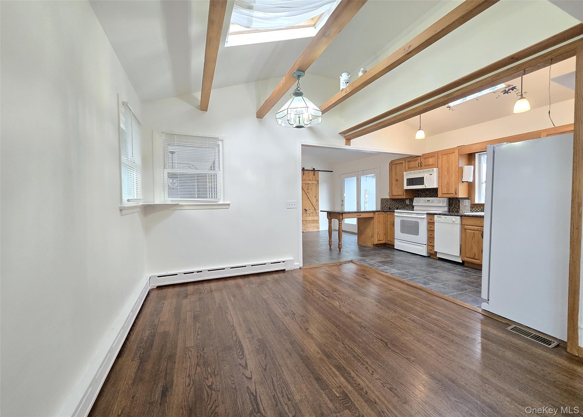 27 Forest Trail Ridge, NY 11961 - Photo 9 of 29 Lovely Dining Rm W/Beamed Vaulted Ceiling, Skylight, Natural Light, & Hardwood Flooring.