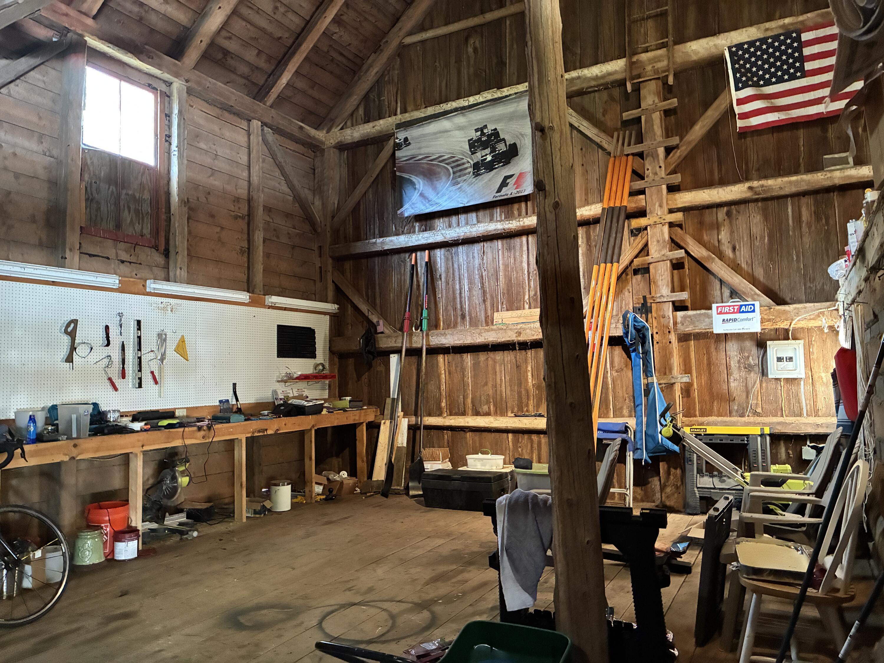 79 Point Road Hancock, ME 04640 - Photo 39 of 59 Workshop space in barn open to peak.