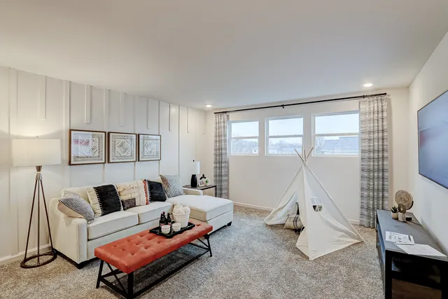 a bedroom with furniture and a large window