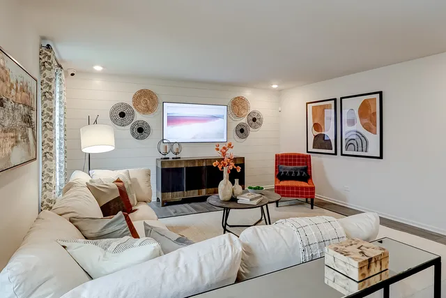 a living room with furniture and wooden floor