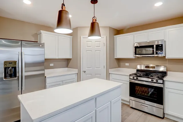 a kitchen with a refrigerator stove and microwave