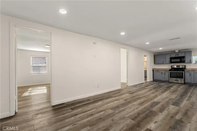 a view of a kitchen with a sink and a refrigerator