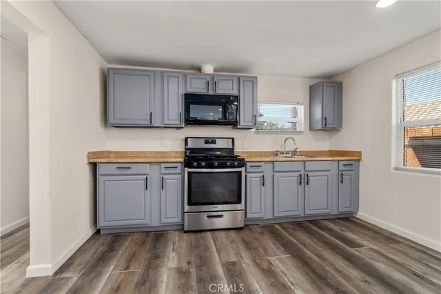 a kitchen with a sink stove and microwave
