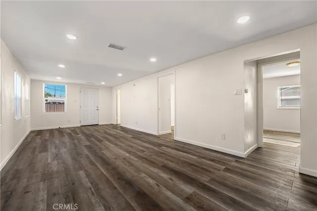 a view of an empty room and wooden floor