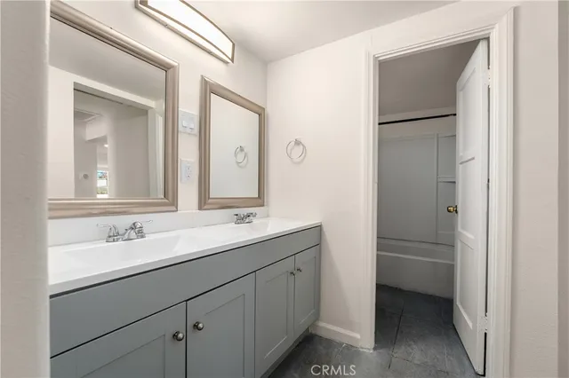 a bathroom with a double vanity sink and mirror