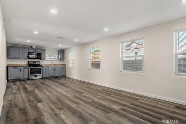 a view of kitchen with stove and cabinets