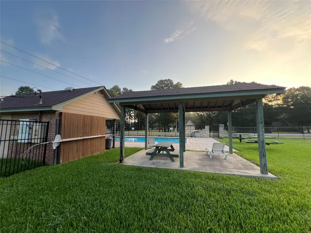 a view of a house with backyard and porch