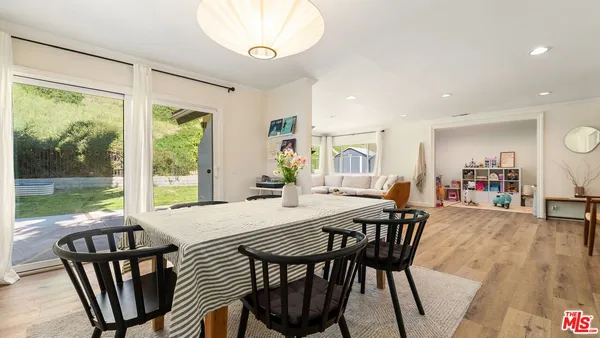 a view of a dining room with furniture window and wooden floor