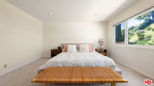 a bedroom with a bed and window