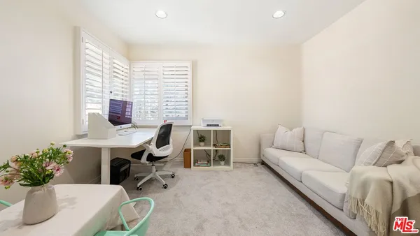 a work room with furniture and a potted plant