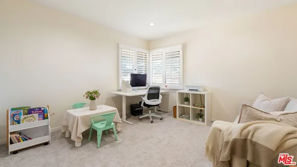 a bedroom with furniture and a window