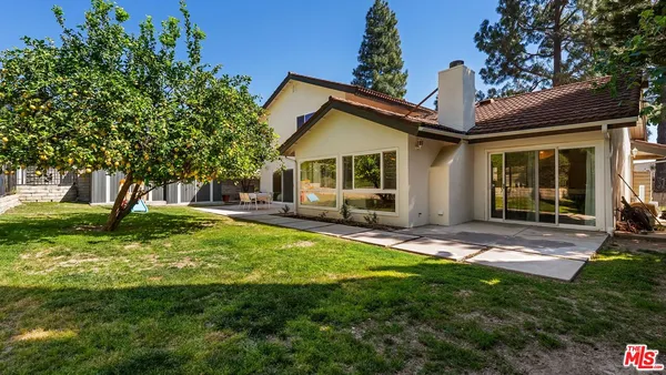 a view of a house with a yard porch and sitting area