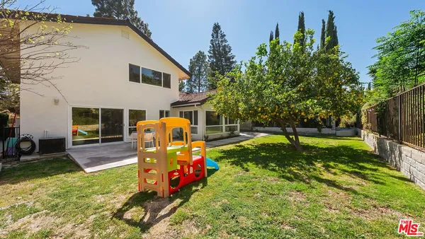 a view of a backyard with swimming pool