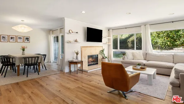 a living room with furniture a fireplace and a flat screen tv
