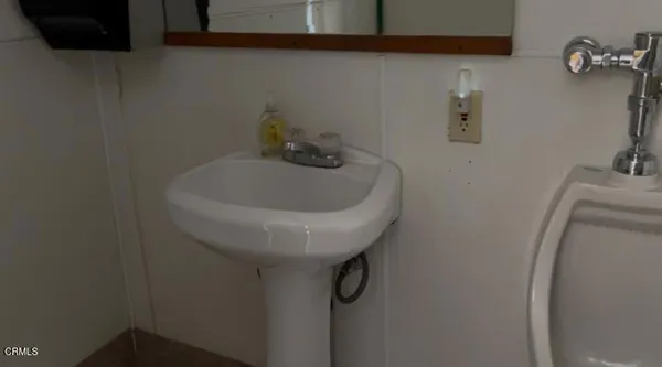a bed sitting in a bedroom next to a window and a bathroom