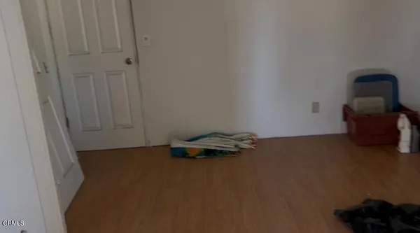 a view of a workspace with furniture and wooden floor