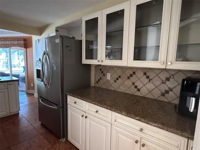 a kitchen with granite countertop a sink stove and cabinets