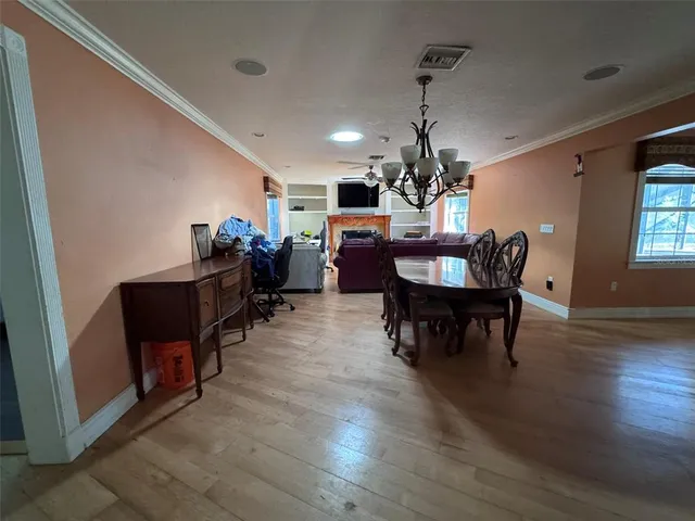 a view of a dining room with furniture and a chandelier