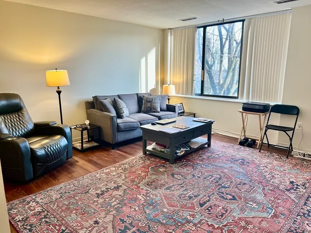 a living room with furniture and a lamp
