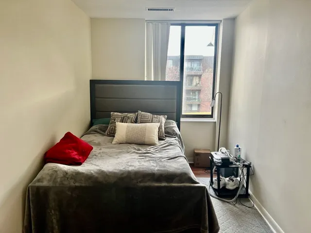 a bedroom with a bed and a mirror