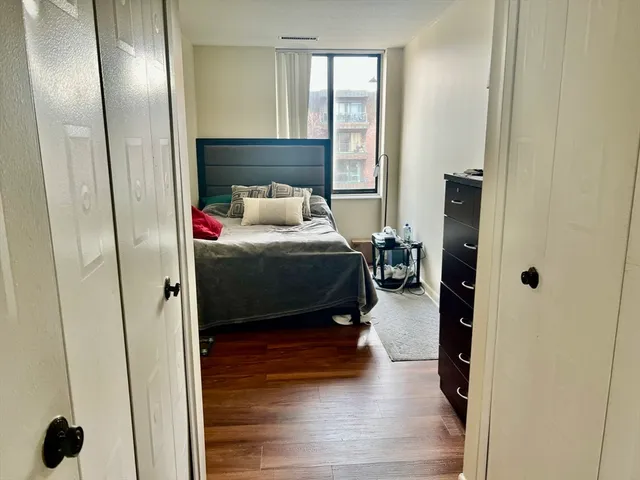 a bedroom with a bed and a lamp on the table