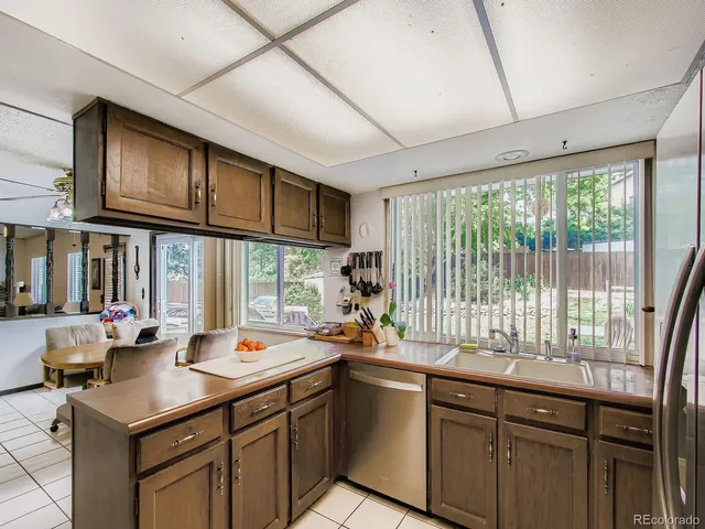 a kitchen with a sink and large windows