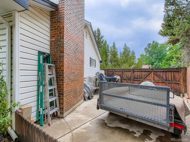 a view of a roof deck with couches and wooden floor