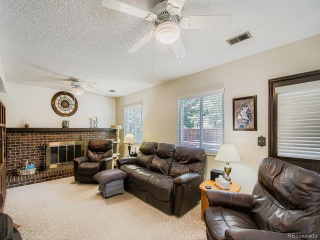a living room with furniture a fireplace and window
