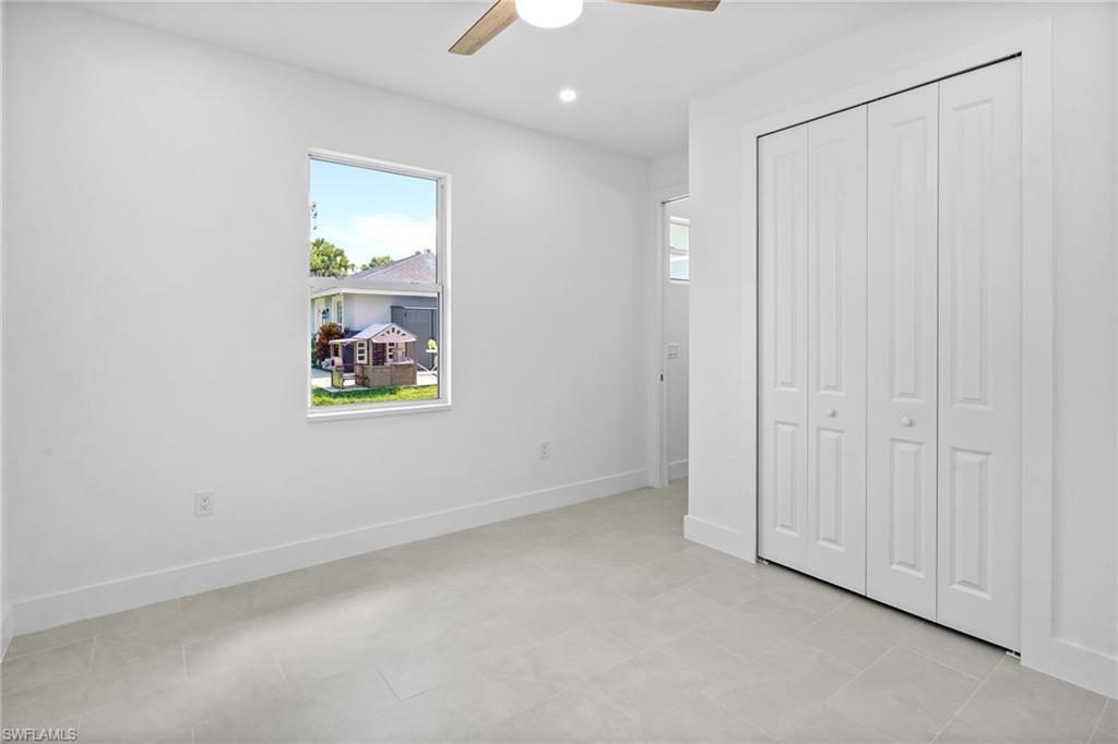 2936 40th Avenue Southeast Naples, FL 34117 - Photo 14 of 49 Unfurnished bedroom featuring a ceiling fan, a closet, and recessed lighting