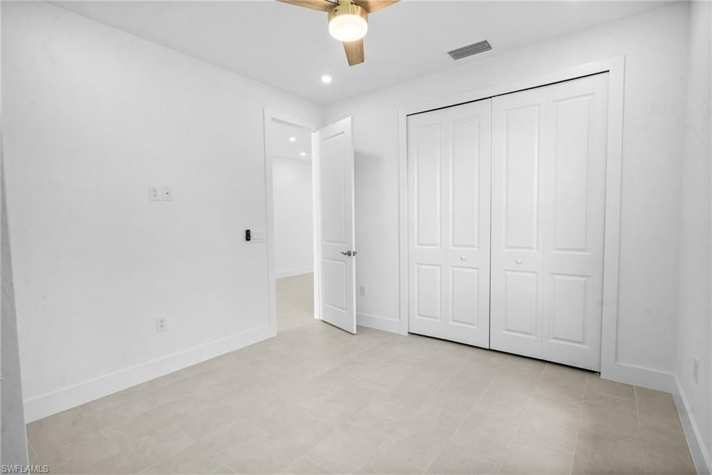 2936 40th Avenue Southeast Naples, FL 34117 - Photo 16 of 49 Unfurnished bedroom with a ceiling fan, recessed lighting, and a closet