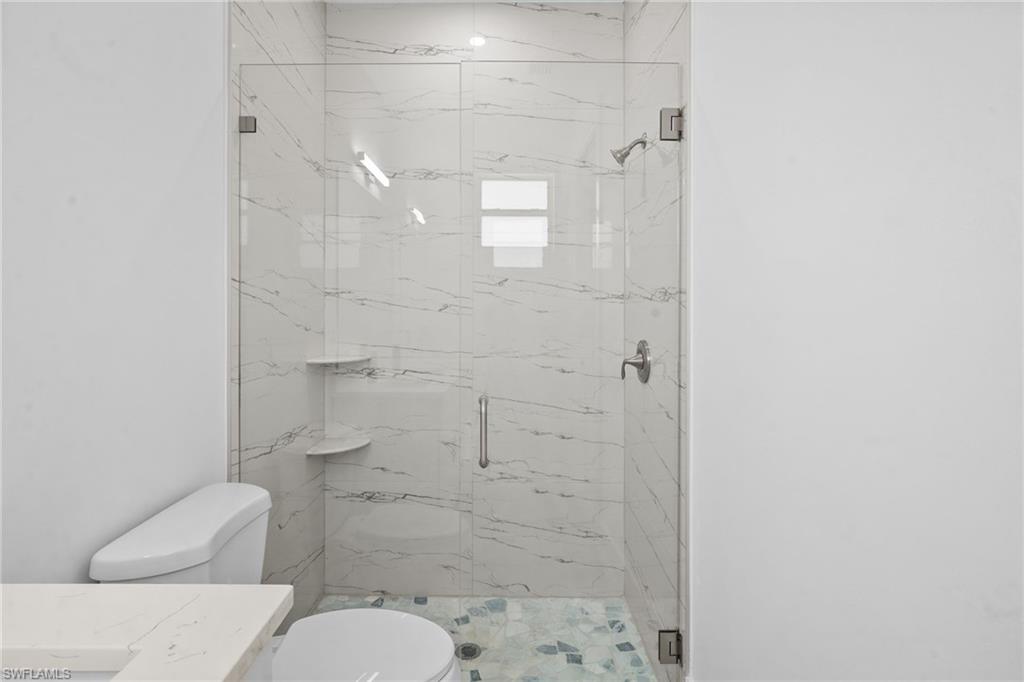 2936 40th Avenue Southeast Naples, FL 34117 - Photo 18 of 49 Full bathroom featuring a marble finish shower and vanity