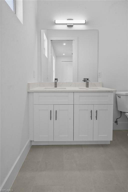 2936 40th Avenue Southeast Naples, FL 34117 - Photo 19 of 49 Bathroom featuring double vanity and light tile patterned flooring