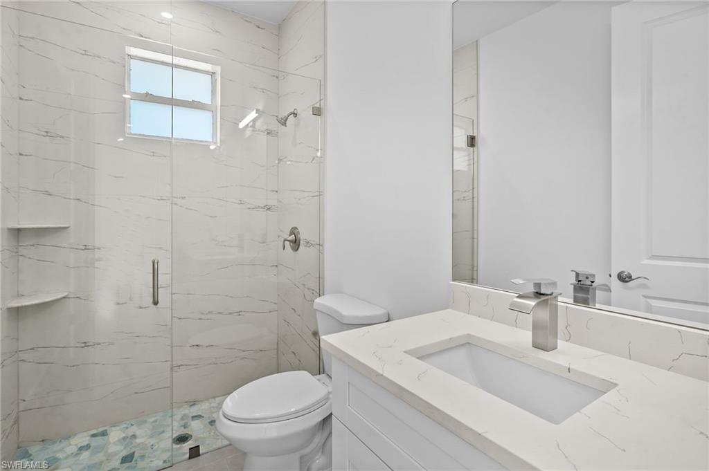 2936 40th Avenue Southeast Naples, FL 34117 - Photo 21 of 49 Bathroom with a marble finish shower and vanity