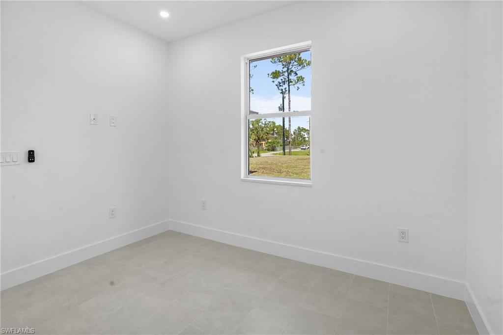 2936 40th Avenue Southeast Naples, FL 34117 - Photo 23 of 49 Empty room featuring baseboards and recessed lighting