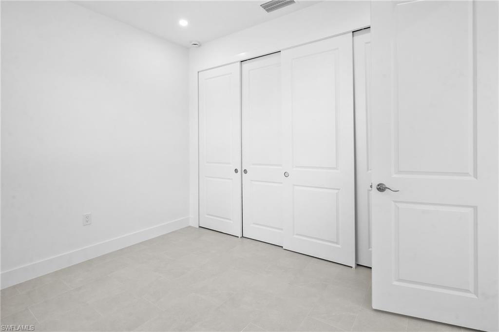 2936 40th Avenue Southeast Naples, FL 34117 - Photo 25 of 49 Unfurnished bedroom with recessed lighting and a closet