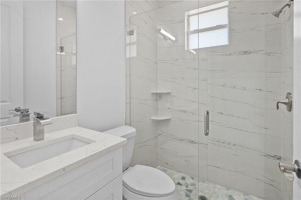 2936 40th Avenue Southeast Naples, FL 34117 - Photo 32 of 49 Full bath featuring a marble finish shower and vanity