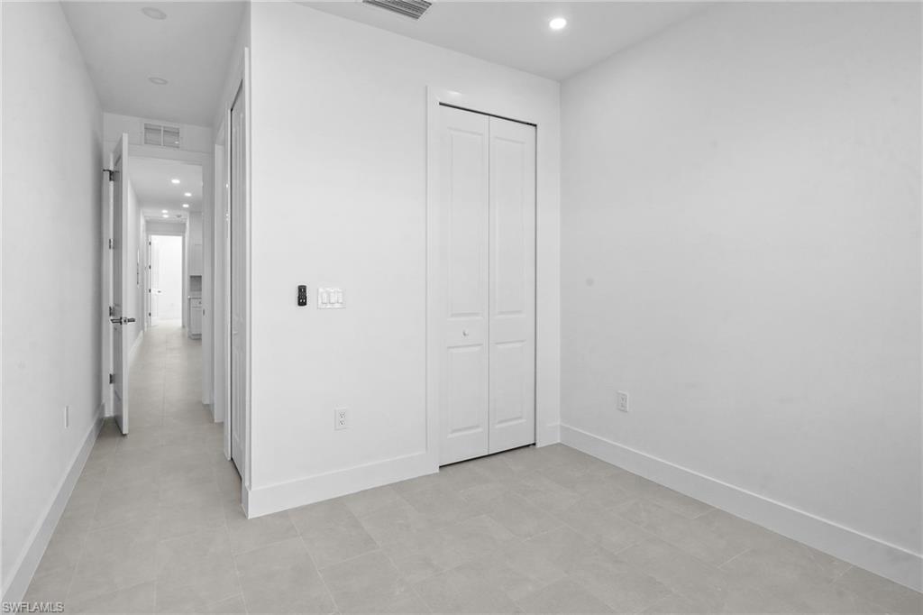 2936 40th Avenue Southeast Naples, FL 34117 - Photo 35 of 49 Unfurnished bedroom with recessed lighting and a closet