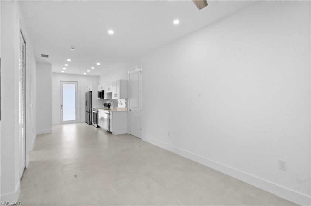 2936 40th Avenue Southeast Naples, FL 34117 - Photo 4 of 49 Unfurnished living room with recessed lighting and light flooring