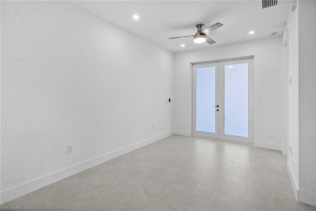 2936 40th Avenue Southeast Naples, FL 34117 - Photo 5 of 49 Spare room with a ceiling fan, french doors, and recessed lighting