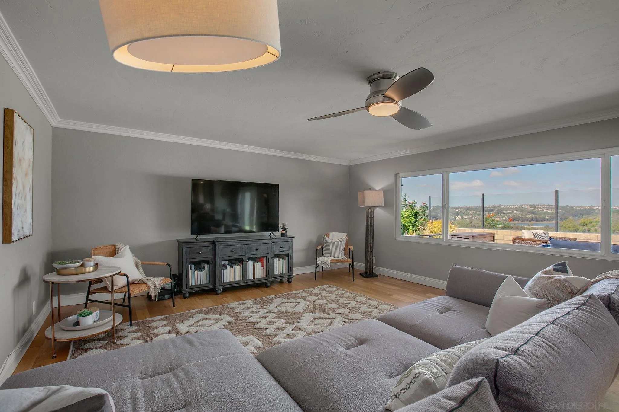 1625 Eolus Avenue Encinitas, CA 92024 - Photo 11 of 37 a living room with furniture a window and a chandelier